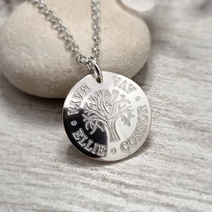tree of life necklace engraved with up to four names, curved around the edge of the 20mm sterling silver disc. A tree of life symbol is in the centre of the piece.