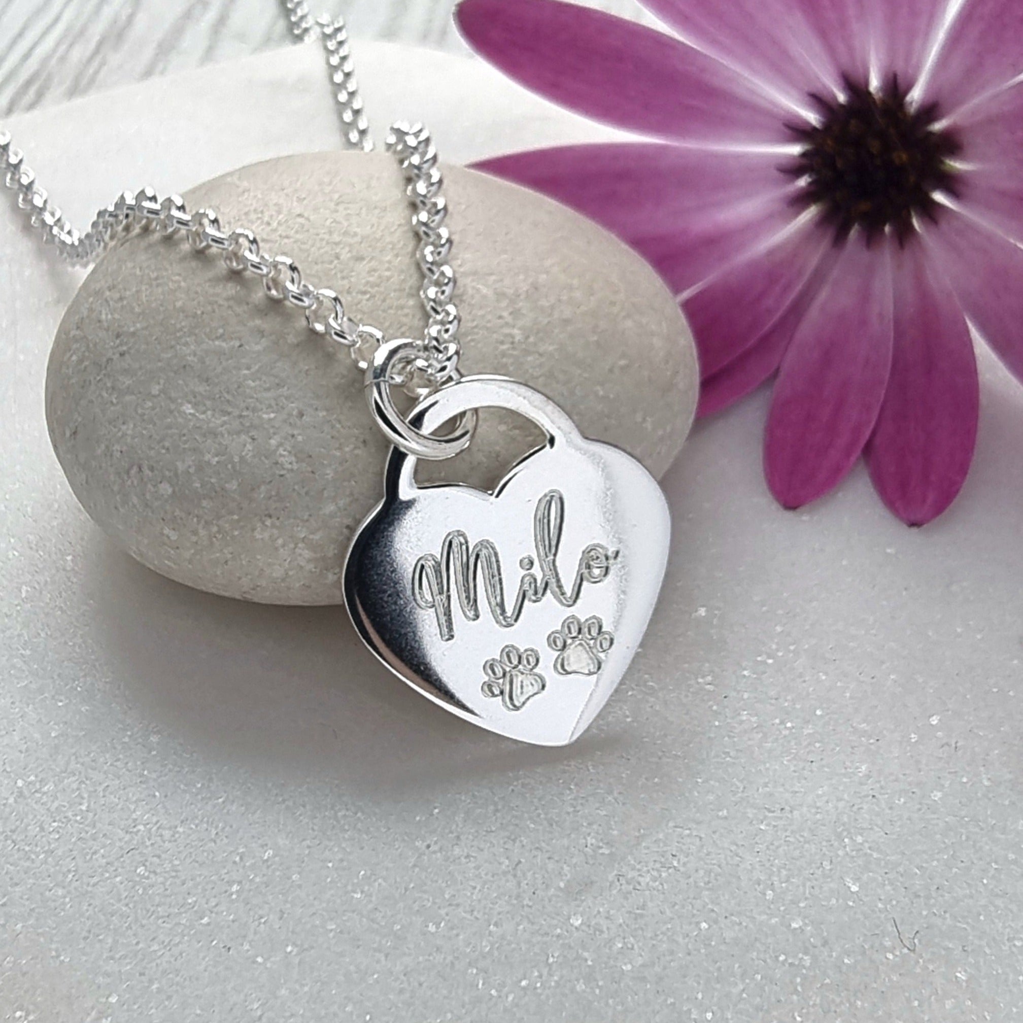 personalised silver necklace engraved with dog, cat or pet name and two tiny paw prints. 