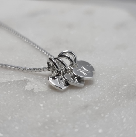 Personalised initial necklace, tiny sterling silver heart charms with one letter engraved on each. Add up to 6 hearts.