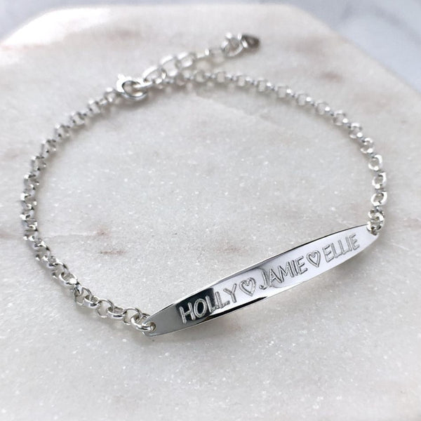 Personalised sterling silver ID bracelet, up to three names (25 letters including spaces) engraved on a 40mm long oval bar. The bracelet measures 7 inches with a one inch extender chain, making it adjustable to 8 inches. 