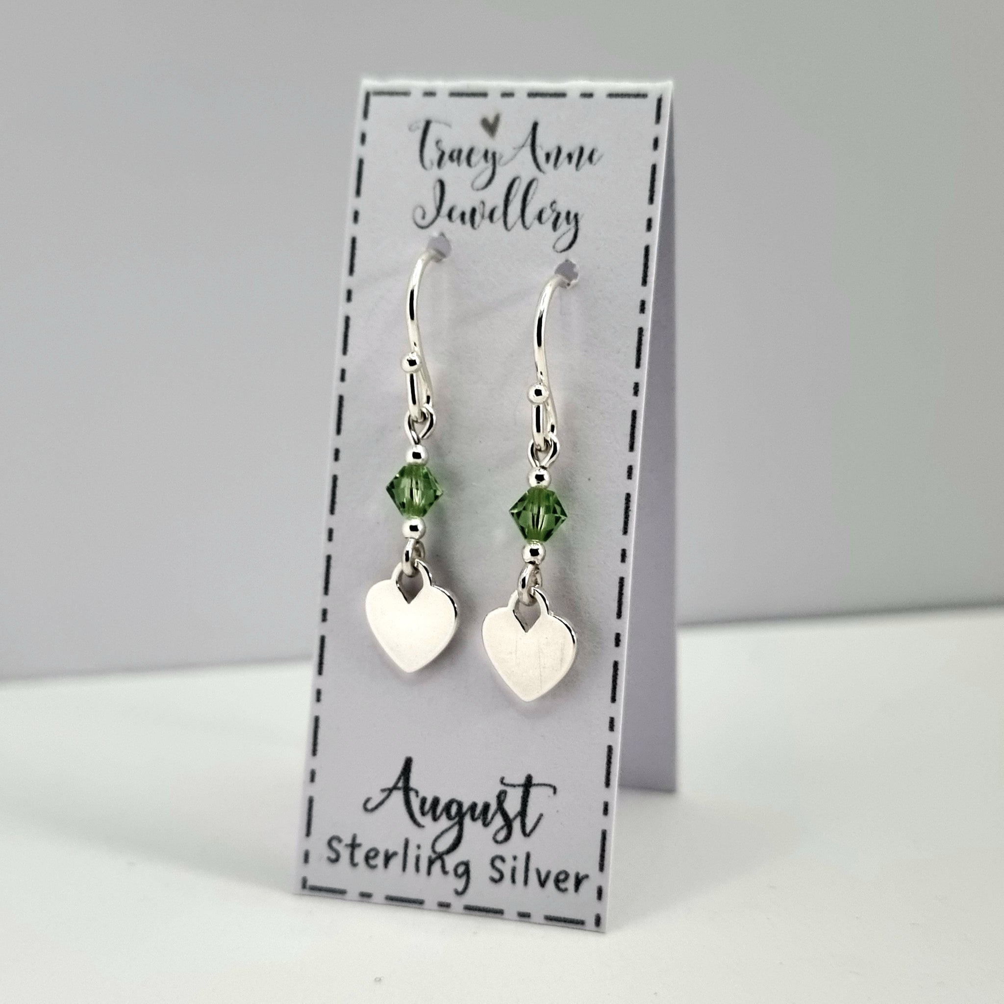 Dainty birthstone earrings with solid sterling silver hearts and tiny crystal beads, available in all twelve colours.