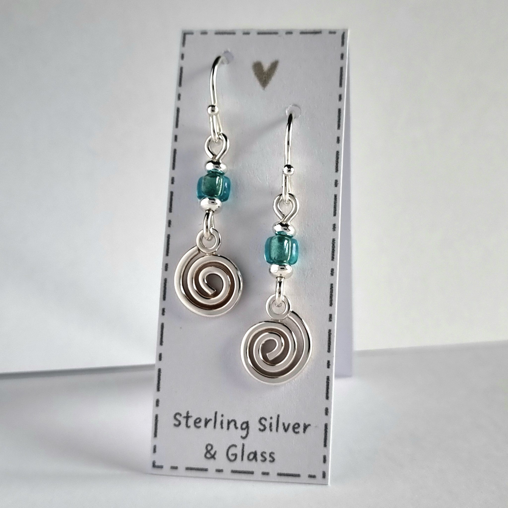 Handmade sterling silver spiral earrings with blue glass bead