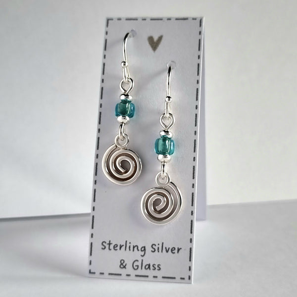 Handmade sterling silver spiral earrings with blue glass bead