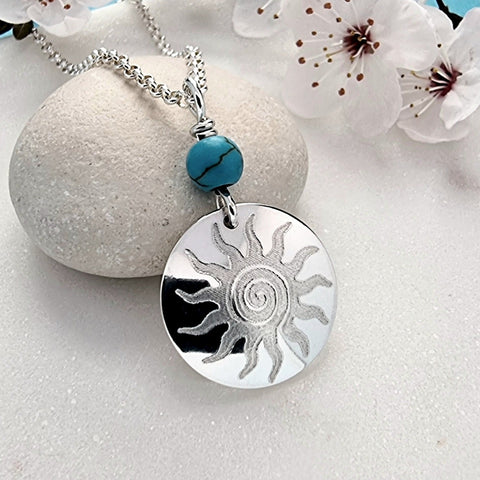 boho style necklace with turquoise bead and engraved sun design