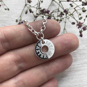 Silver charm bracelet with dog, cat or pet name engraved onto silver washer charm. Up to four names will fit, two on each side of the washer with a maximum of ten letters on each side.
