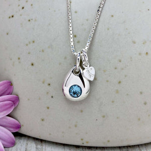 Birthstone necklace. A small and dainty teardrop pendant, inset with a beautiful crystal and personalised with a tiny monogram heart charm.