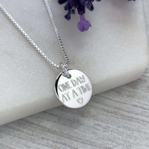 One day at a time, motivational gift, addiction recovery, sobriety, mental health. Engraved sterling silver 12mm disc pendant with chain.
