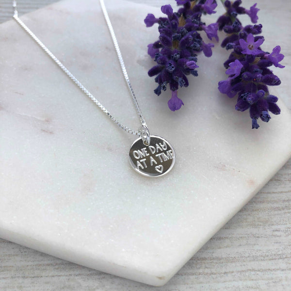 One day at a time, motivational gift, addiction recovery, sobriety, mental health. Engraved sterling silver 12mm disc pendant with chain.
