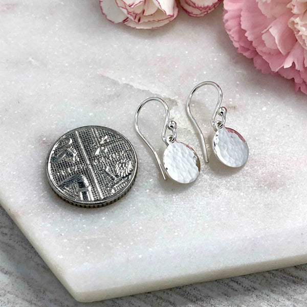 small silver drop earring with hammered finish. 8mm wide sterling silver discs