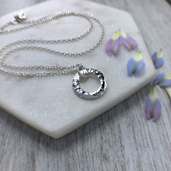 Simple, minimalist silver necklace with hammered finish