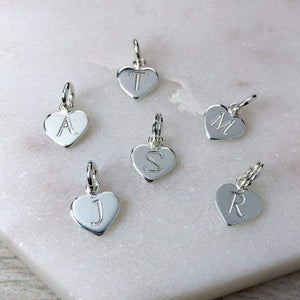 Tiny initial charms engraved onto 8mm wide sterling silver hearts
