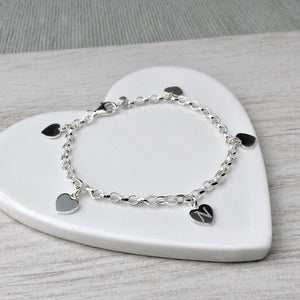 Sterling silver charm bracelet with small engraved heart charms
